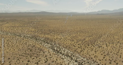 Drone footage of flat desert lands, helicopter aerial