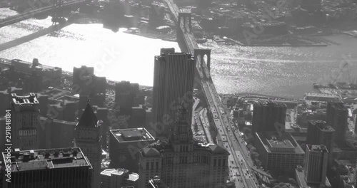 Black and white aerial shot, pan over Brooklyn Bridge to Williamsburg bridge, drone