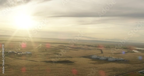 Helicopter aerial shot of sunlight pouring over fields, drone