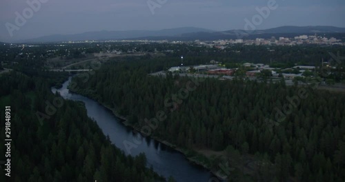Helicopter aerial shot over river, moving toward city in Washingtion