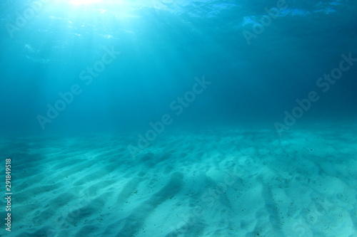 Blue underwater background photo of sea and sand 