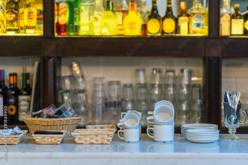 Stainless bar counter with mugs and beverage under tidy arrangement Stainless bar counter with mugs and beverage under tidy arrangement