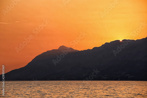 Silhouette of the mountain by the orange sunset