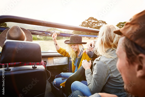 Woman dancing to music in front seat
