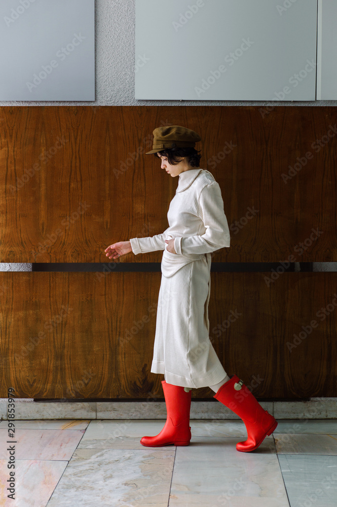 Woman in warm dress and gumboots Woman in warm dress and gumboots