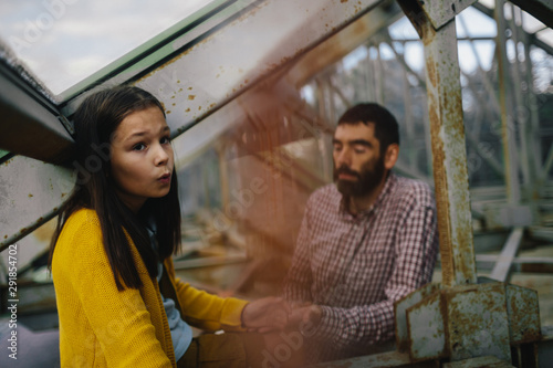 Man and little girl in the greenhouse