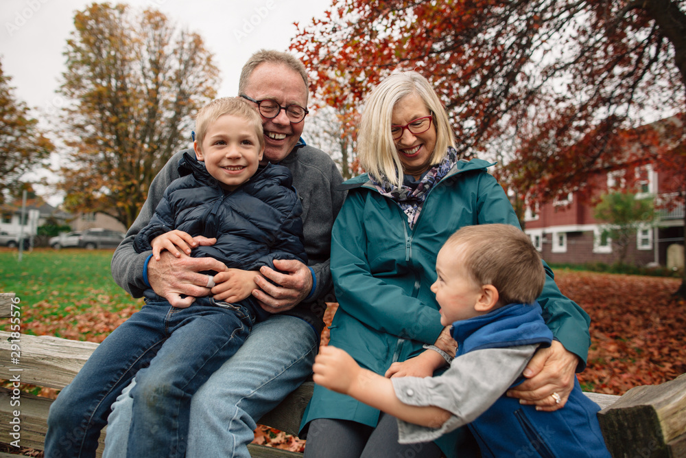 Mature couple playing with kids outside Mature couple playing with kids outside