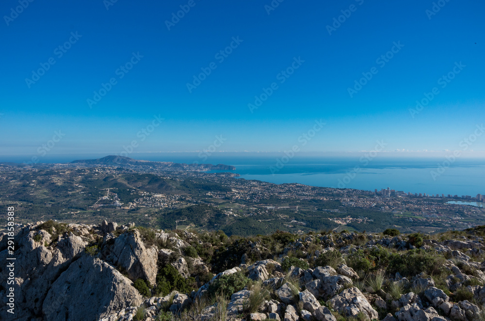 Panoramic view to Mediterranean sea and Calp area from cliffs on mountain range Serra d'Oltà, Spain