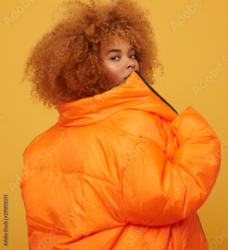 Young woman studio portrait giving back