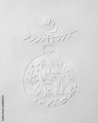 Paper with an embossed fir branch pattern with a Christmas decor