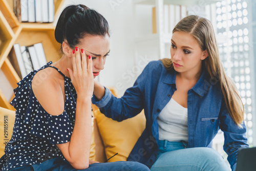 Young frustrated woman working at office desk in front of laptop suffering from chronic daily headaches, treatment online, appointing to a medical consultation, electromagnetic radiation, sick pay.