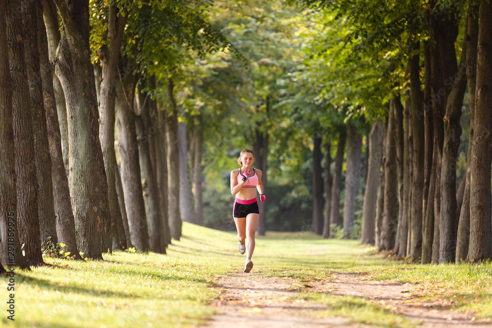 sport girl making exercises outdoors. Young sport woman in a park. Sport and fitness on open air. Exercise lunge leg on the grass and stretching sport girl making exercises outdoors. Young sport woman in a park. Sport and fitness on open air. Exercise lunge leg on the grass and stretching