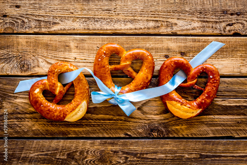 Octoberfest symbol. Fresh bavarian pretzels on rustic wooden background top view copy space