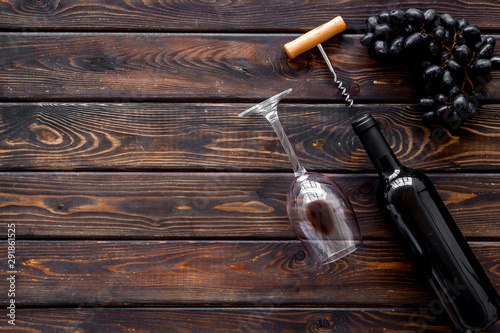 Composition with wine bottle on dark wooden background top view copy space