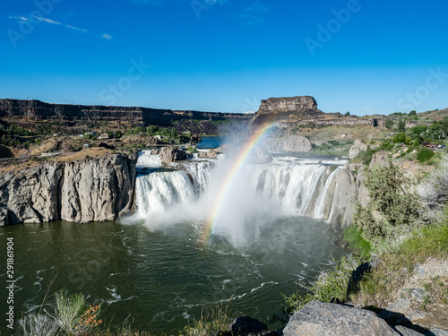 Shoshone Falls Park on bright, sunny summer day with mist and rainbow over waterfall, Twin Falls, Idaho, USA