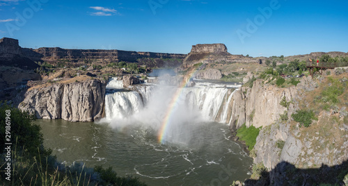 Shoshone Falls Park on bright, sunny summer day with mist and rainbow over waterfall, Twin Falls, Idaho, USA