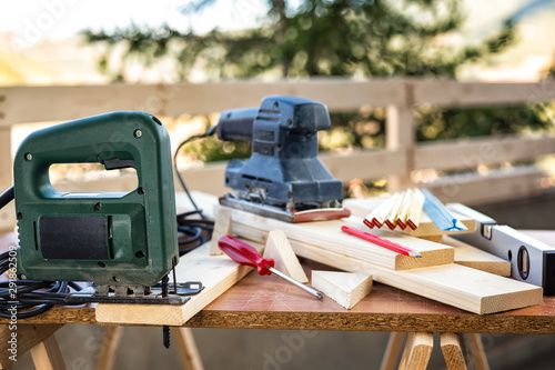 Professional woodworking tools, manual electric saw for cutting wood. Housework do it yourself. Stock photography.