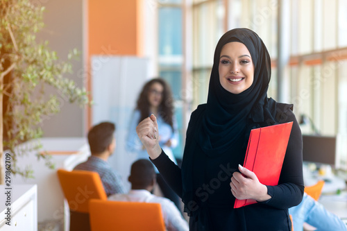 Fotografie, Tablou Arabic business woman working in team with her colleagues at office