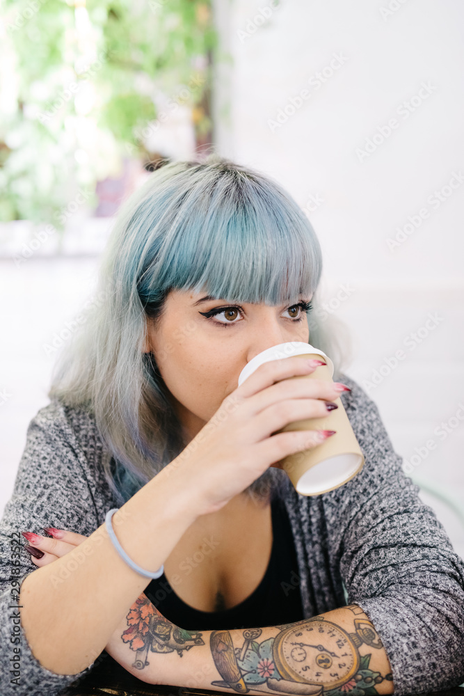 Cheerful stylish woman having coffee with friend Cheerful stylish woman having coffee with friend