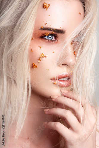 Beautiful blonde woman with creative make up art