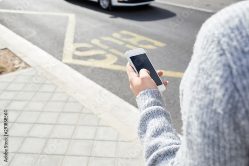 Female hands using smartphone street.