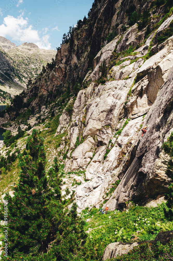Woman climbing in scenic mountain valley