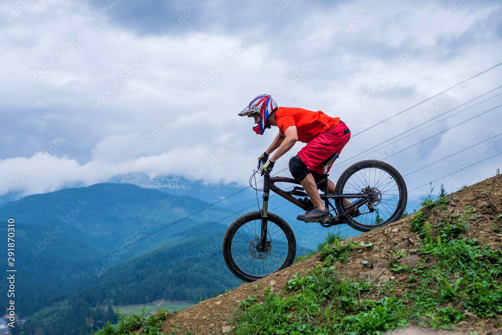 Fototapeta premium Cyclist riding a mountain bike from a mountain.