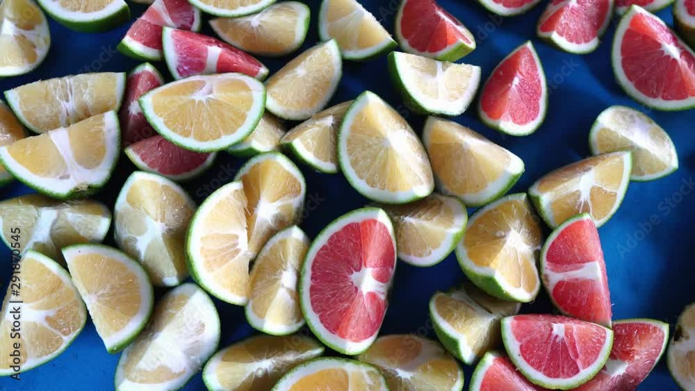 set of yellow and red oranges cut into wedges to be tasted on a table