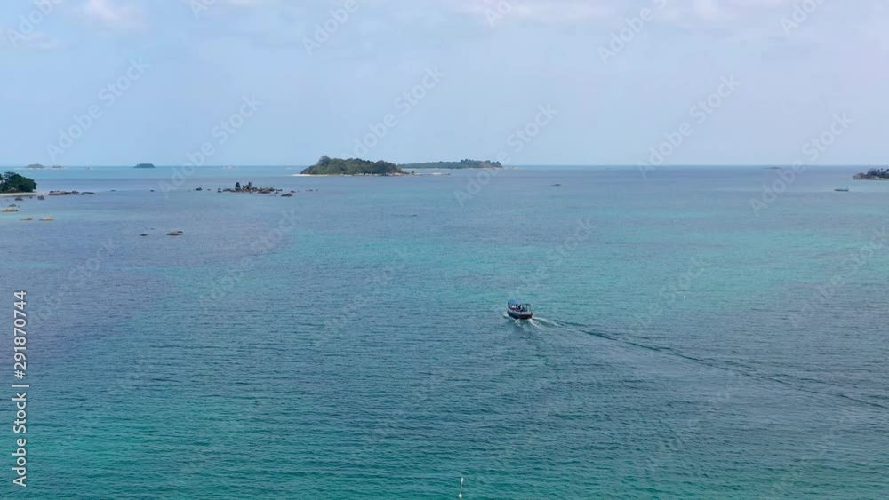 4K Aerial flying over beautiful bay of Tanjung Kelayang of Belitung Island. view of wooden boats, white sandy beach, tree, clear water, cloud and sky 4K Aerial flying over beautiful bay of Tanjung Kelayang of Belitung Island. view of wooden boats, white sandy beach, tree, clear water, cloud and sky