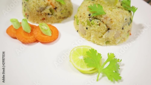 Rotating Close up of South Indian morning breakfast Upma or uppittu on Plate. photo