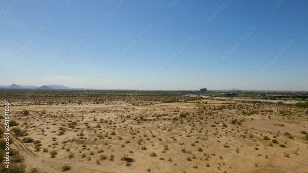 Smooth Ascending Aerial shot over vast desert land with busy freeway and highway Smooth Ascending Aerial shot over vast desert land with busy freeway and highway