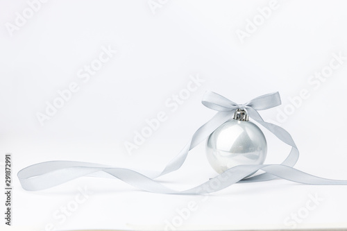 Fototapeta Naklejka Na Ścianę i Meble -  Christmas balls with silver ribbon on white background. Christmas decor and toys. 