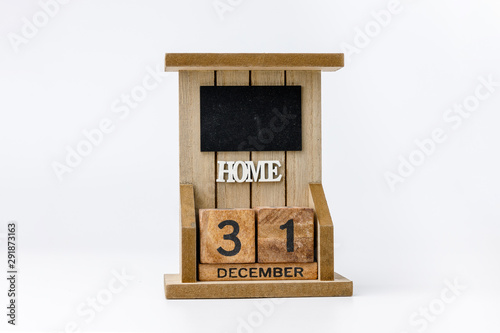 Business and design concept - geometric floating wooden cube on white background. 31st Desember. Happy New Year.