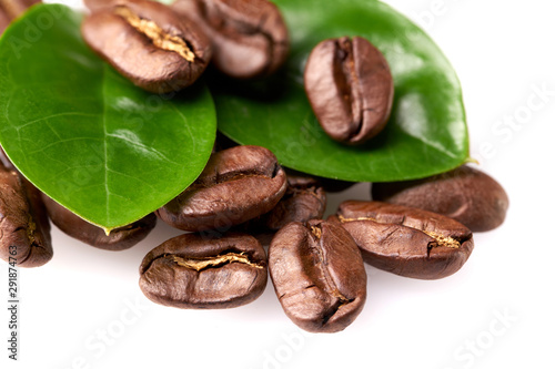 coffee beans with two green leaves on a white background, isolate. concept: freshness of coffee beans.