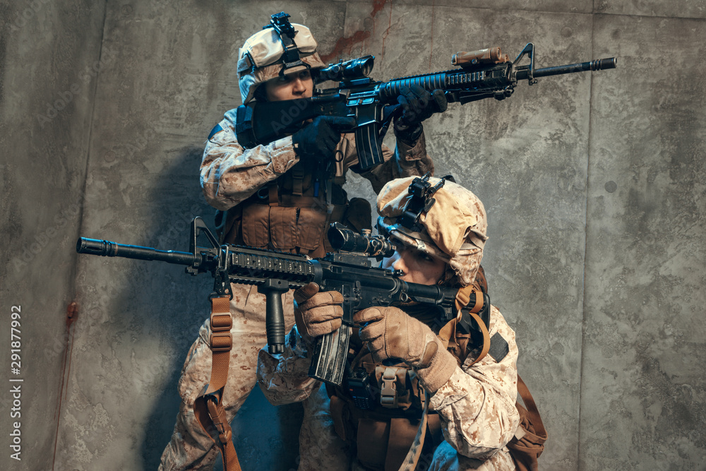 Fototapeta premium US special operations forces fighters armed with assault rifle, in opscore helmet. Studio shot