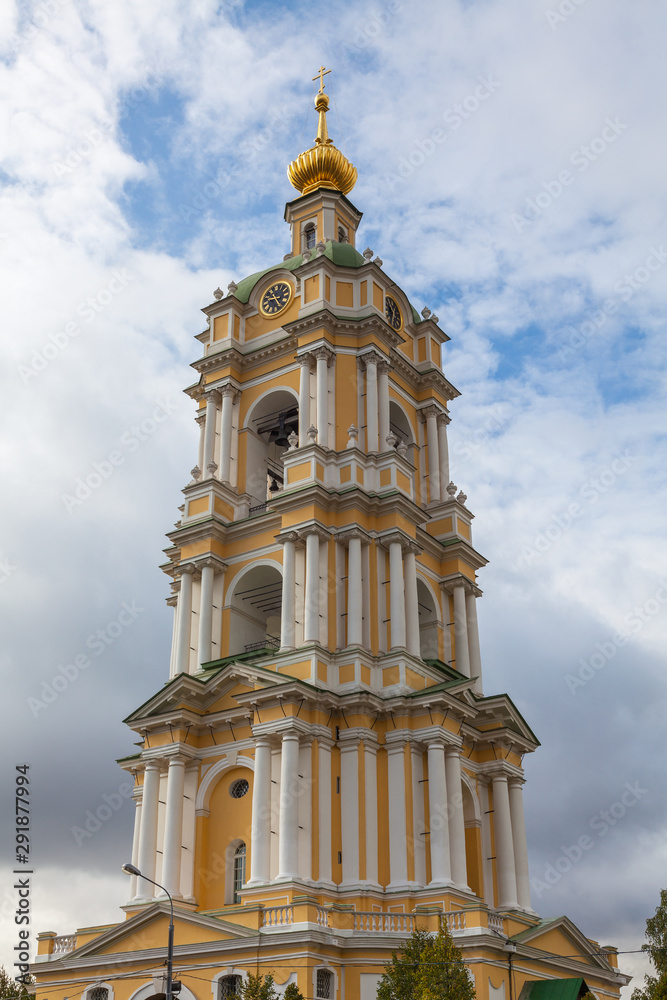 The bell tower of the Novospassky Monastery against a cloudy sky. The photo was taken in early autumn, in the afternoon, under natural light
