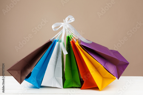 Arrangement of shopping bags on beige background