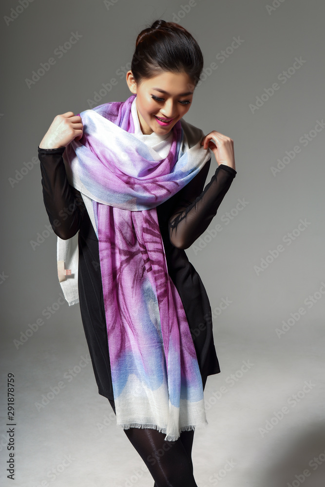 Asian woman wearing chinese silk scarf taking pictures on grey background  Stock Photo | Adobe Stock