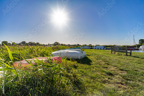 10 Small boats on the river bank at Thurne Dyke Norfolk photo