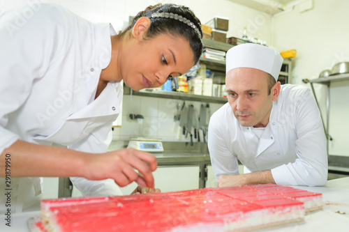 Photography female pastry cook holding tray of pastries