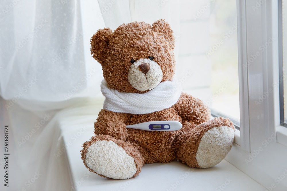concept teddy bear childhood diseases on white background. Teddy Bear sitting alone on white window