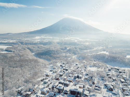 Winter in Niseko, Japan. A Blue bird kind of day at Grand Hirafu, Niseko Ski Resort. Photos were taken with a drone overlooking the Grand Hirafu area with views of Mt. Niseko-Annupuri. and Mt. Yotei.
