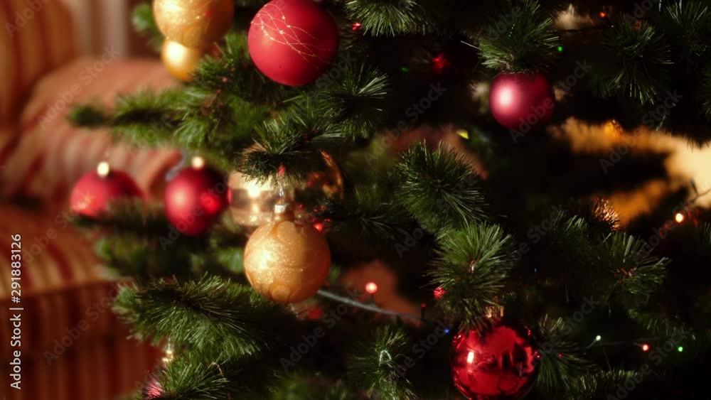 4k video of camera slowly moving and panning over colorful glowing lights and baubles on Christmas tree at living room 4k video of camera slowly moving and panning over colorful glowing lights and baubles on Christmas tree at living room