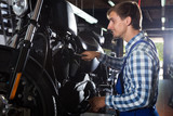 young male mechanic working in auto repair shop