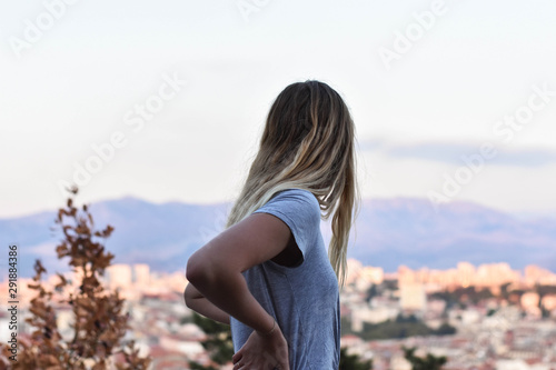 Young blonde woman looking town from the up