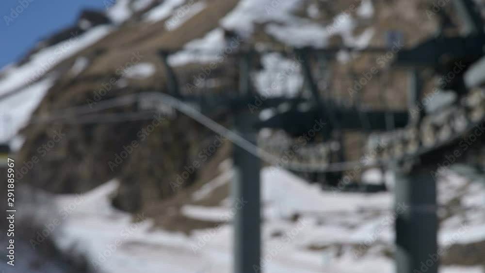 The mechanism of the cable car to the cable car for the transport of passengers in blur or defocus,. Close-up rollers and pulleys running on the cable car. The mechanism of the cable car to the cable car for the transport of passengers in blur or defocus,. Close-up rollers and pulleys running on the cable car.