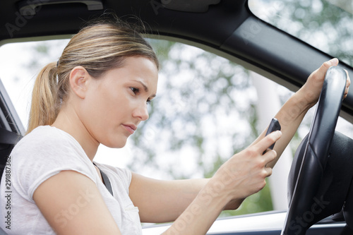 close-up of woman driving and texting © auremar