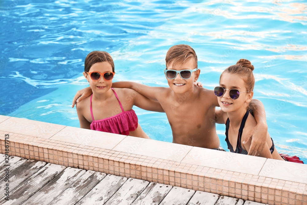 Happy children in swimming pool on sunny day Happy children in swimming pool on sunny day