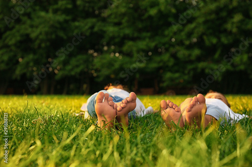 Happy children lying on grass in park