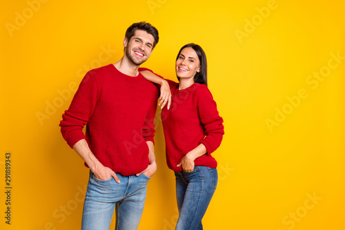 Portrait of charming woman lean on her husband shoulder feel joy smile stand isolated over yellow background © deagreez